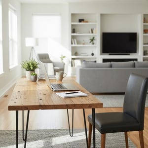 May include: A rectangular wooden desk with a natural grain finish and four black metal hairpin legs. The desk surface holds a silver laptop, a white spiral-bound notebook with a black pen, two small potted green plants, and a ceramic mug.