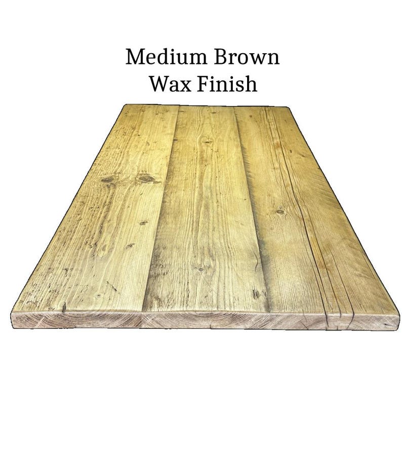 May include: A rectangular wooden tabletop featuring a medium brown wax finish. The surface is composed of three joined planks displaying natural wood grain patterns, knots, and visible texture. The text Medium Brown Wax Finish is centered above.