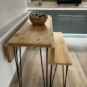 May include: A trio of ceramic mugs with a speckled, matte finish in cream, light grey, and dark grey. Each mug features a simple, minimalist design, ideal for tea or coffee.