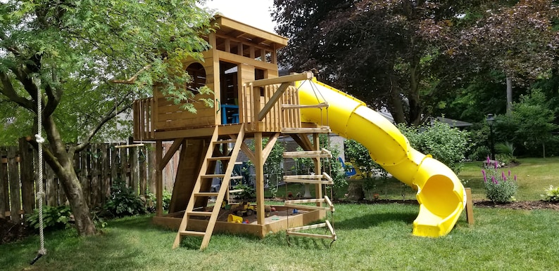 May include: A wooden playset with a slide, ladder, and climbing wall. The slide is yellow and the playset is made of natural wood.