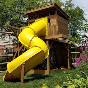 May include: A yellow plastic slide attached to a wooden treehouse playset. The slide is curved and has a wooden platform at the top.