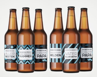May include: Six brown glass beer bottles with blue and black labels. The labels have different designs and text in German. The text on the labels includes "Ein Bier für den" and phrases like "Aller Besten", "Coolsten Papa", and "Vater Aller Zeiten".