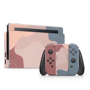 May include: A pink, blue, and brown abstract design Nintendo Switch console and controller. The console and controller have a modern, minimalist design with a soft, muted color palette.