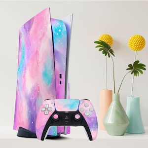 May include: A white PlayStation 5 console with a pink, purple, and blue galaxy-themed skin. The console is standing upright and next to it is a matching galaxy-themed controller.