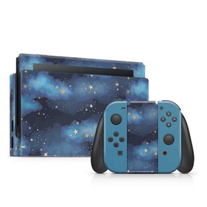 May include: A blue and gold Nintendo Switch console and controller with a starry night sky design. The console and controller are both covered in a pattern of clouds and stars.