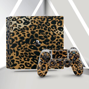 May include: A PlayStation 4 console and controller set featuring a leopard print design in shades of brown and black. The console is positioned upright, with the controller resting in front. The background is a modern, minimalist design.