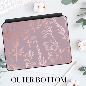 May include: A pink and rose gold laptop skin with a floral pattern. The design features delicate, stylized flowers and leaves in a repeating pattern.