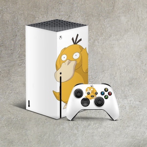 May include: A white Xbox Series X console with a custom skin featuring a yellow Pokemon character. The character is a Psyduck with a surprised expression. The console is next to a white Xbox Series X controller with a matching Psyduck skin.