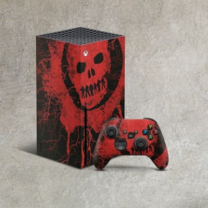 May include: A black Xbox Series X console and matching wireless controller featuring a red graphic skin. The design displays a large red skull motif with a silhouette of figures across the jawline, accented by red splatter and vein-like patterns.