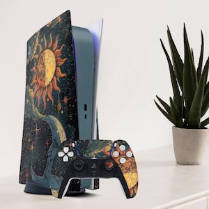 May include: A PlayStation 5 console and controller skin set. The console has a celestial design with a sun, moon, and stars in orange, yellow, and blue. The controller has a matching design. The set is displayed on a white surface.