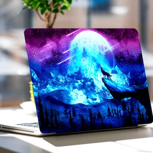May include: A laptop skin with a blue and purple galaxy design featuring a wolf howling at a full moon over a mountain range.