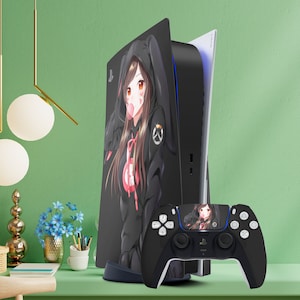May include: A black and white custom skin for the Playstation 5 console featuring an anime character with pink hair and a black hoodie. The skin is also on a black DualSense controller with a similar anime character design.