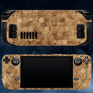 May include: A handheld games console with a wood-effect honeycomb pattern. The console has a black screen, buttons, and joysticks. The top and bottom of the console are visible, showcasing the design.