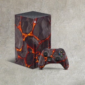 May include: A black and orange Xbox Series X console with a lava rock design and a matching black and orange controller.