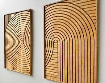 May include: Two wooden wall art pieces with geometric patterns. The piece on the left has a spiral design, while the piece on the right has a series of concentric circles and straight lines.