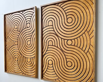 May include: Two wooden wall art pieces with a geometric pattern of overlapping circles and curves. The wood is a light brown color and the pattern is carved into the surface.