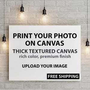 May include: A white canvas with black text that reads "PRINT YOUR PHOTO ON CANVAS". The canvas also states "THICK TEXTURED CANVAS rich color, premium finish" and "UPLOAD YOUR IMAGE". The background is a brick wall with hanging light fixtures.