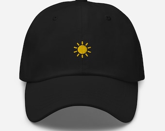 May include: A black baseball cap with a yellow embroidered sun design.