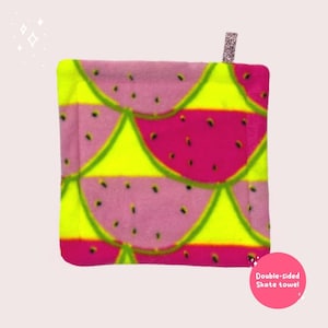 May include: Double-sided skate towel with a watermelon print. One side is pink with green watermelon slices and the other side is neon yellow with pink watermelon slices.