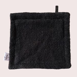May include: Black kitchen scrubby with a textured surface. The scrubby is made of a soft, absorbent material.