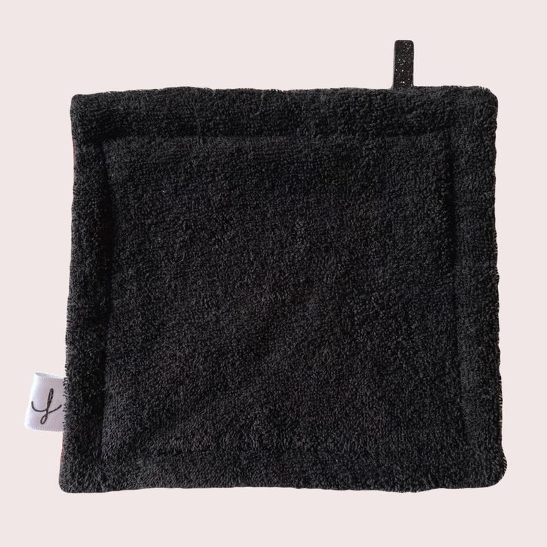 May include: Black kitchen scrubby with a textured surface. The scrubby is made of a soft, absorbent material.