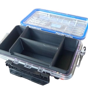 May include: A clear, rectangular storage box with a blue rim and a transparent lid. The interior features black compartments for organization. The box has a black latch and hinges for secure closure, ideal for small items.