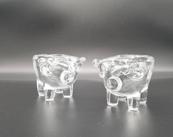 Bertil Vallien for Kosta Boda, Sweden.  A Pair of Moulded Glass Candleholders in the Form of Pigs. 1970s.