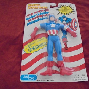 May include: Captain America action figure on a card. The figure is blue, red, and white, with the text "Marvel Super-Hero Captain America" and "Twistables". The packaging reads "50th Anniversary Collectors Edition".