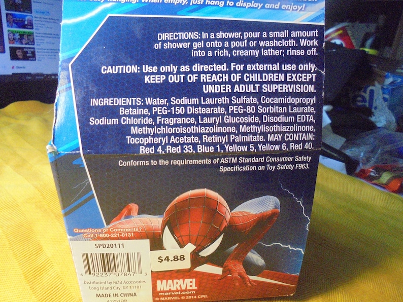 May include: A blue cardboard product box featuring a Spider-Man graphic, directions for shower gel use, caution warnings, and a full list of ingredients including water, sodium laureth sulfate, and various colorants. A barcode and Marvel logo are visible.