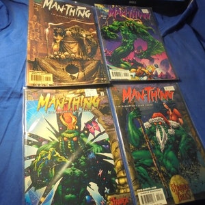 May include: Four comic books featuring the Man-Thing, a swamp monster superhero. The covers feature different illustrations of the Man-Thing in various settings, including a jungle, a snowy landscape, and a cosmic background. The comic books are titled "Man-Thing" and feature the text "Jim Shooter's Swamp Thing".