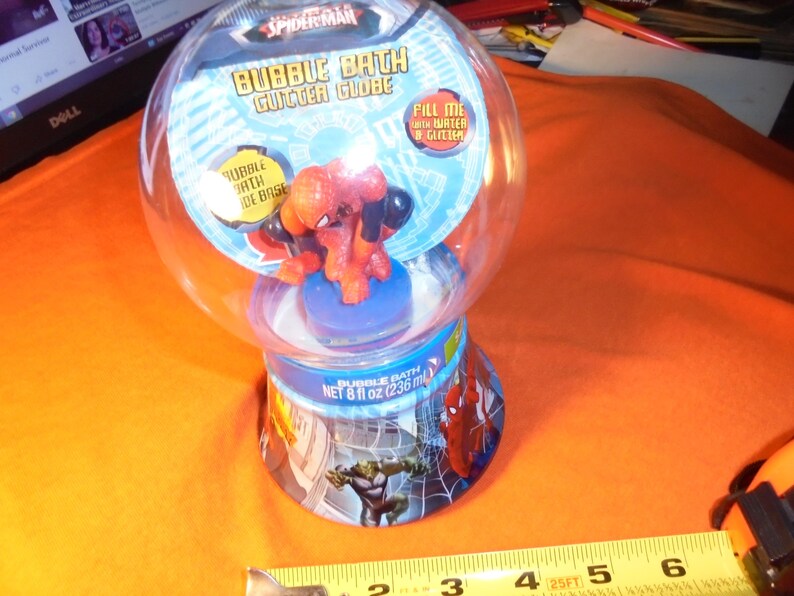 May include: A Spider-Man Bubble Bath Gutter Globe. The clear plastic globe contains a Spider-Man figurine. The base of the globe has images of Spider-Man and the Hulk. The product contains 8 fl oz (236 ml) of bubble bath.
