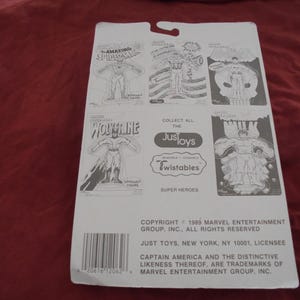 May include: A white cardboard backing for Just Toys Super Heroes action figures. The backing features illustrations of Spider-Man, Wolverine, and Captain America. The text includes "Collect All The Just Toys Twistables Super Heroes."