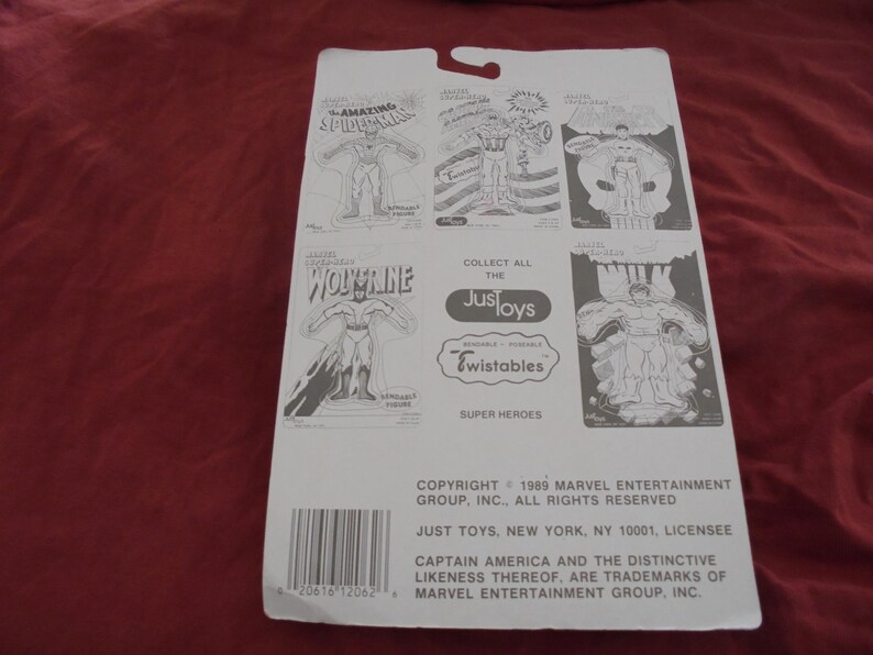 May include: A white cardboard backing for Just Toys Super Heroes action figures. The backing features illustrations of Spider-Man, Wolverine, and Captain America. The text includes "Collect All The Just Toys Twistables Super Heroes."
