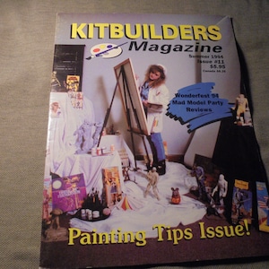 May include: The cover of Kitbuilders Magazine, Summer 1994, features a painting theme. The magazine cover has the text "Painting Tips Issue!" and "Wonderfest 94 Mad Model Party Reviews". The cover shows a person painting on a canvas.