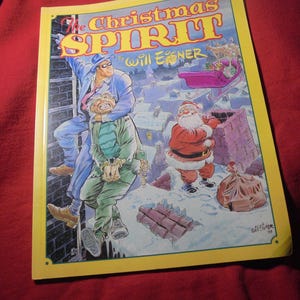 May include: A graphic novel titled The Christmas Spirit by Will Eisner with a yellow border. The cover illustration depicts a masked figure in a blue suit climbing a brick wall, a person in green clothing, and Santa Claus standing on a snowy roof.