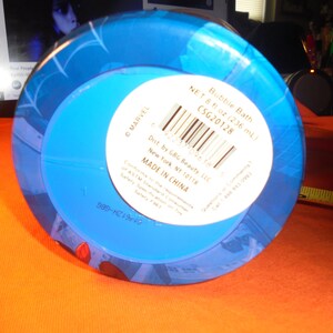 May include: A blue bubble bath container with a white label. The label includes the text "Bubble Bath" and "NET 8 fl oz (236 ml)". The container has a blue design and the text "MADE IN CHINA".