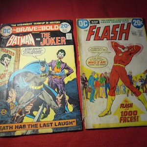 May include: Two vintage DC Comics: "The Brave and the Bold" featuring Batman and the Joker, and "The Flash." The Batman comic shows Batman and the Joker with the text "Death Has The Last Laugh." The Flash comic features the Flash with the text "The Flash of 1000 Faces!"
