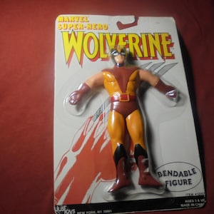 May include: A Wolverine action figure in a blister pack. The figure is in a classic yellow and brown costume with black accents. The packaging reads "Marvel Super-Hero Wolverine" and "Bendable Figure."
