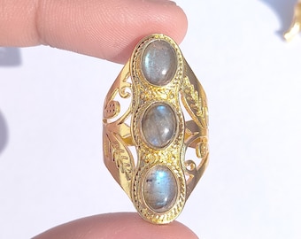 May include: Gold ring with three oval-shaped labradorite gemstones set in a filigree design.