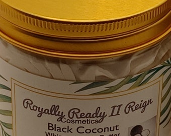 May include: A gold jar with a white label that reads "Royally Ready II Reign Cosmetics Black Coconut Whipped Body Butter Net Wt. 5 (Oz)". The label also features a green leaf design and a drawing of a coconut.