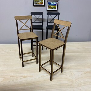 May include: Four wooden chairs with a simple, modern design. Two chairs are brown and two are black. The chairs have a cross-shaped back and a square seat.