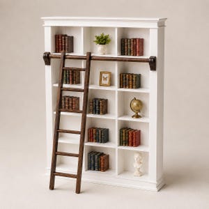 May include: A white wooden bookcase with five shelves divided into three vertical sections. A dark brown rolling ladder is attached to a horizontal rail across the front. The shelves contain various books, a small potted plant, a framed picture, a globe, and a bust.