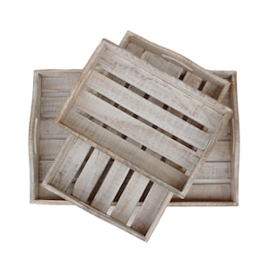 May include: Three wooden trays stacked on top of each other. The trays are made of light-colored wood with a distressed finish. The trays are rectangular in shape and have a rustic look.