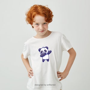 May include: A white t-shirt featuring a cartoon panda bear wearing a blue headband and performing a dabbing pose. The text "designed by snflwrstd" is at the bottom of the shirt.