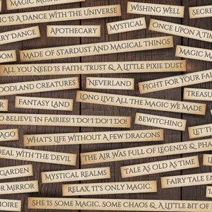May include: A wooden background with various paper strips with magical phrases written on them. The phrases include "Magic is a dance with the universe", "All you need is faith, trust & a little pixie dust", "Fight for your fairytale", "What's life without a few dragons", "The air was full of legends & phantoms", "Relax, it's only magic", and "She is some magic, some chaos & a little bit of poetry".