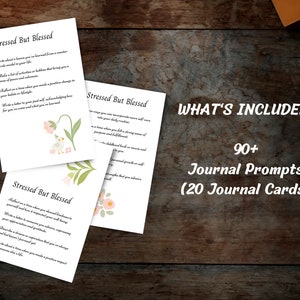 May include: Three printable journal cards with floral illustrations and the text "Stressed But Blessed". Each card features a different journal prompt. The text "WHAT'S INCLUDED: 90+ Journal Prompts (20 Journal Cards)" is displayed at the top of the image.