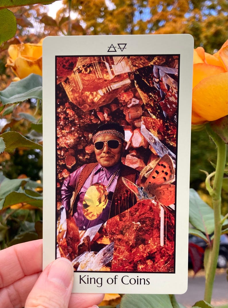 May include: A tarot card featuring a collage of a man in sunglasses, a butterfly, and crystals. The card is labeled "King of Coins" at the bottom. The background includes a collage of orange and brown crystals and a butterfly.