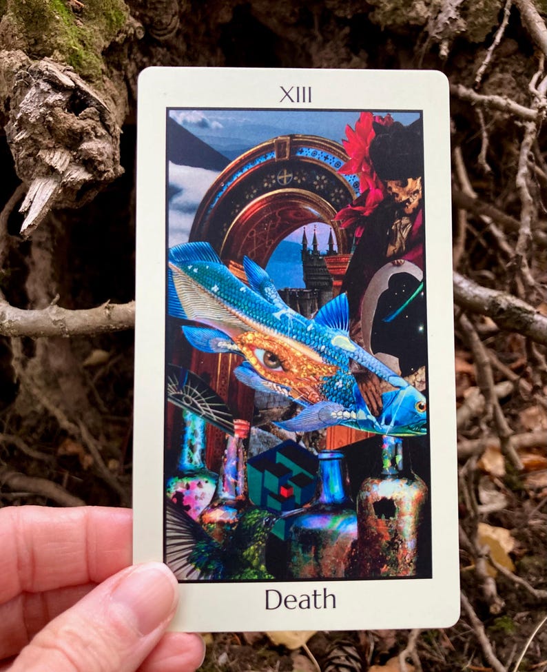 May include: A tarot card featuring a collage of images, including a blue fish with an eye, a figure in a black hat, and various bottles. The card is labeled "XIII" at the top and "Death" at the bottom.