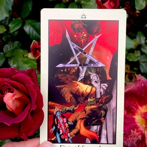 May include: A tarot card with a collage of images, including a silver star, figures in brown clothing, and a blue figure. The card is labeled "Five of Swords" in white text. The background features red and dark green hues.