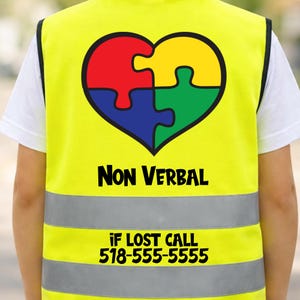 May include: A bright yellow safety vest with a heart-shaped puzzle design in red, yellow, blue, and green. The words "Non Verbal" are printed in black, along with the phone number "518-555-5555" below.
